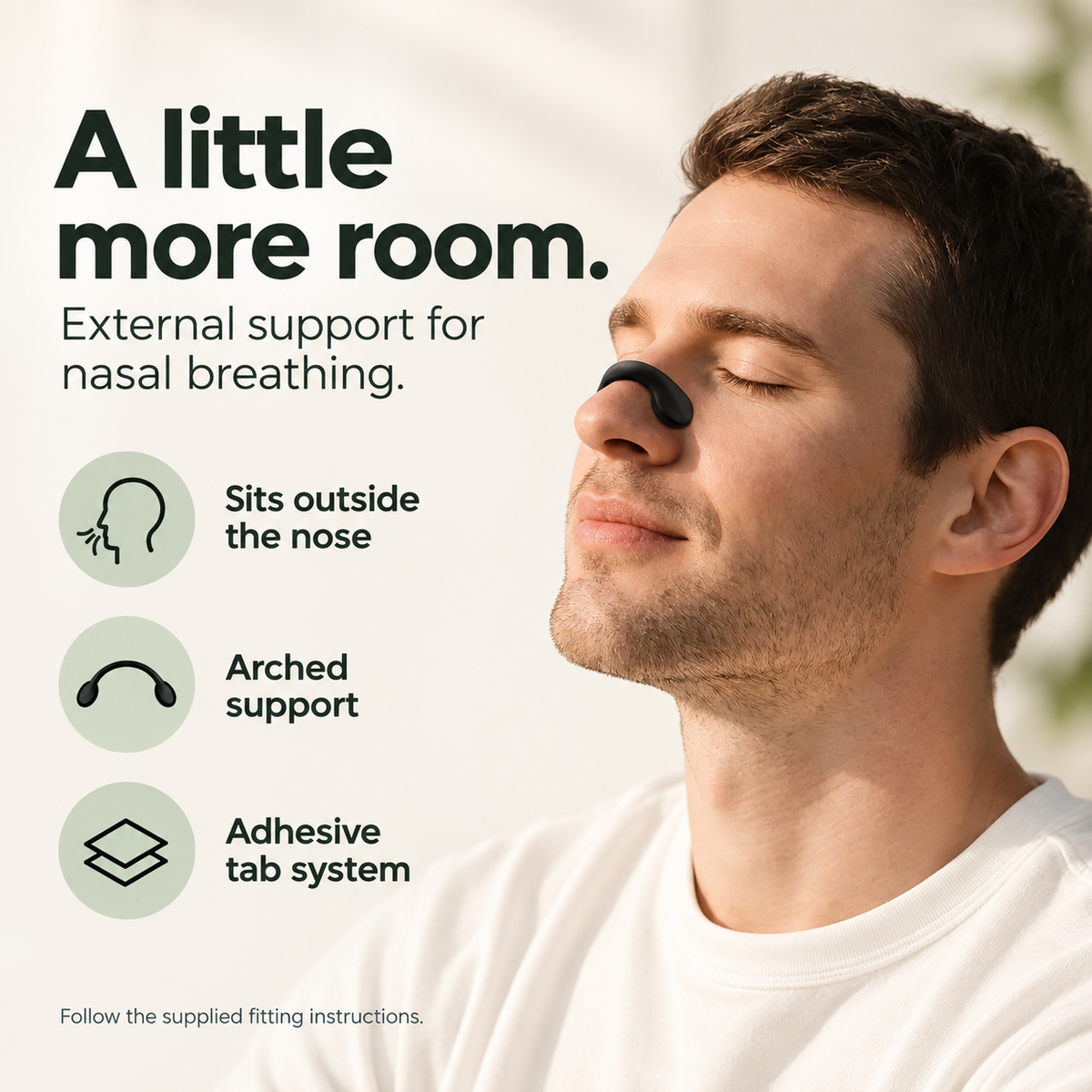 Man wearing a black external nasal support, with arched strip and adhesive tab features.